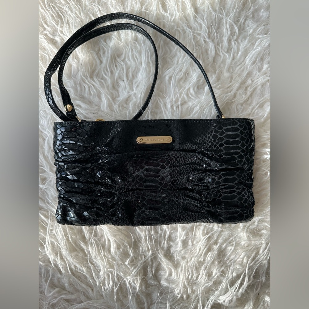 Michael Kors bag. Color black snake print. Gold detail. Zipper close.